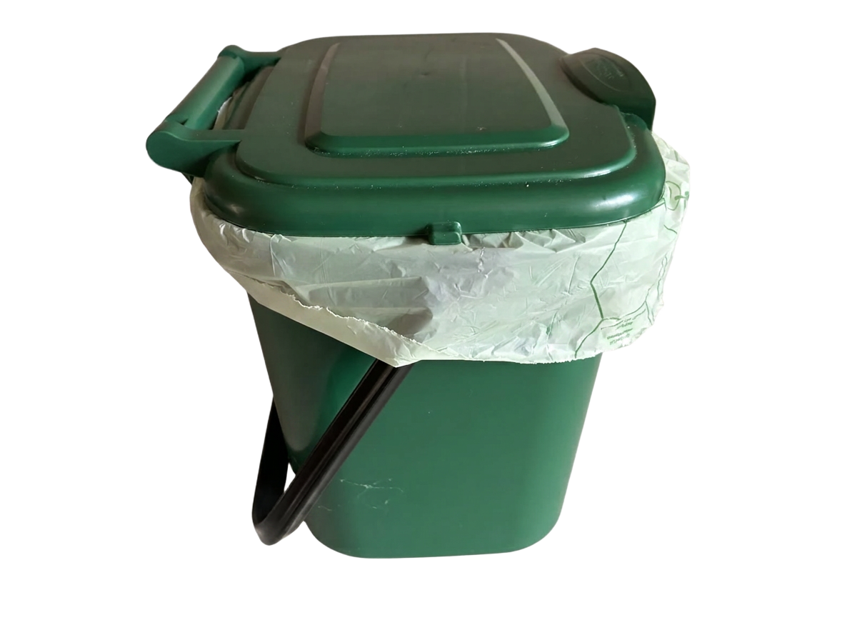 Kitchen caddy bin with the bin bag slipping down inside — the problem Caddy Grip solves